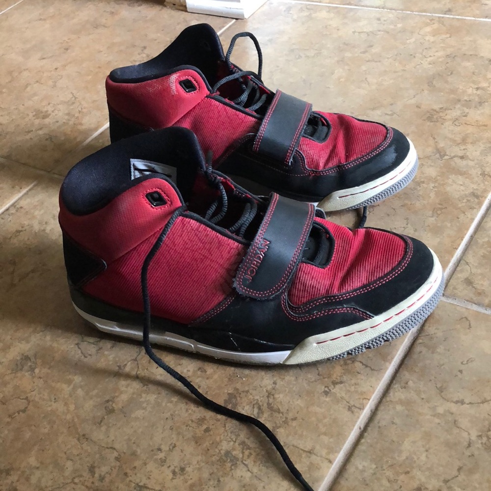 A pair of red and black Jordan’s